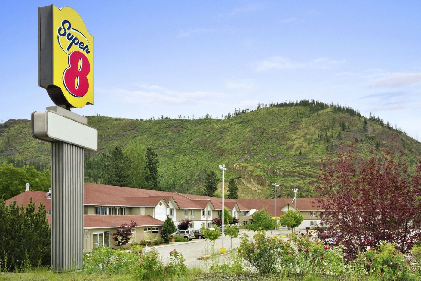 The Super 8 sign above the hotel with the West Kelowna hillside behind