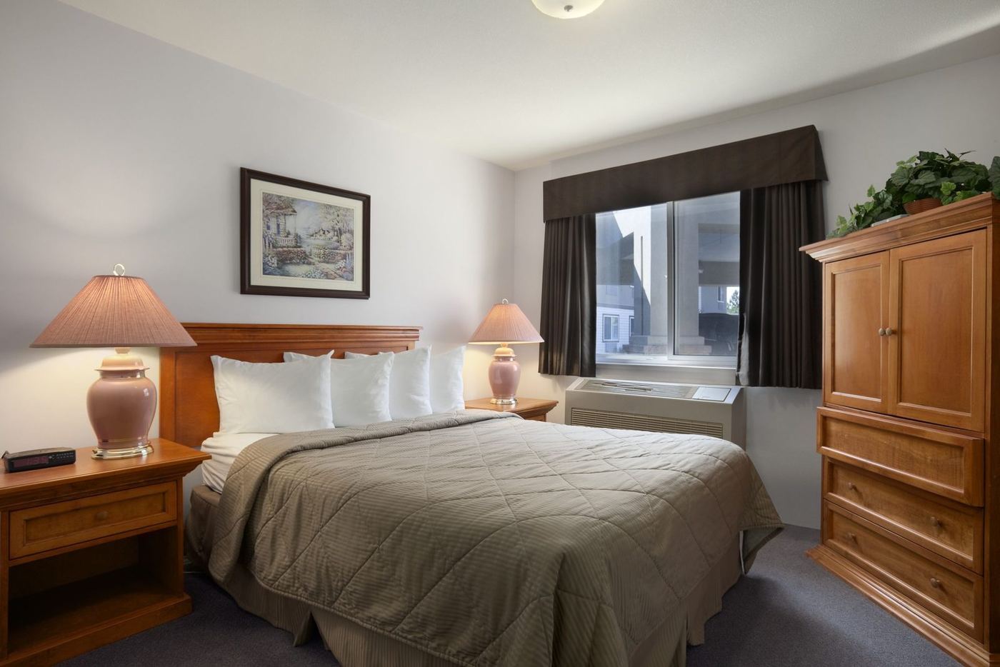 Guest room with a single bed, dresser and window